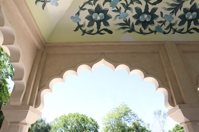 indian inspired fort with intricate painted flowers on ceiling on a summers day