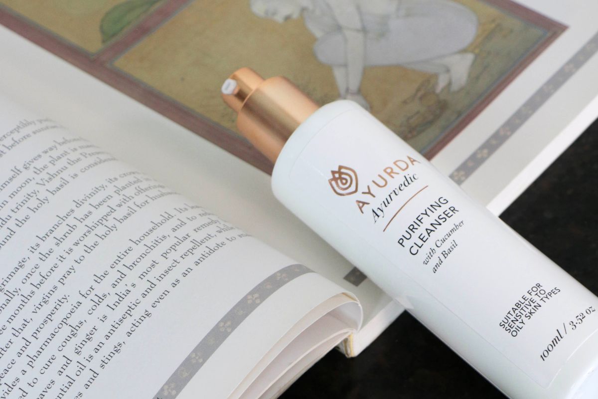 Purifying cleanser lying on ayurvedic book