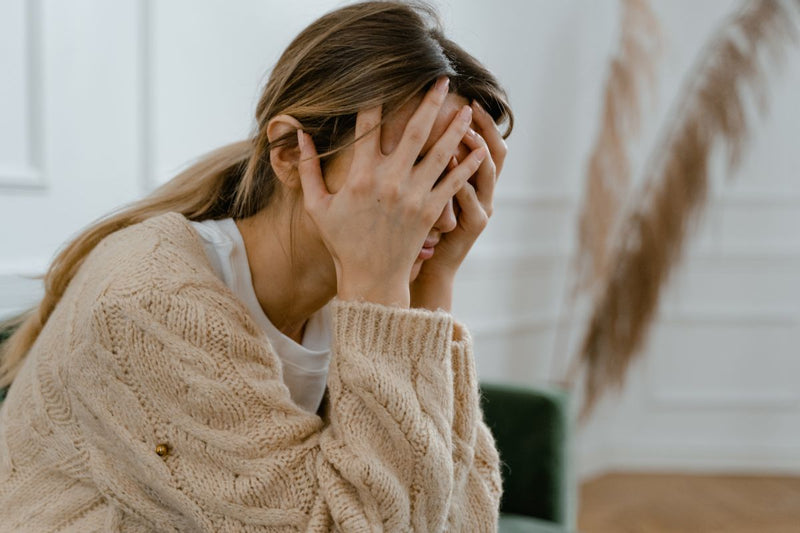 stressed woman with her hands on her head